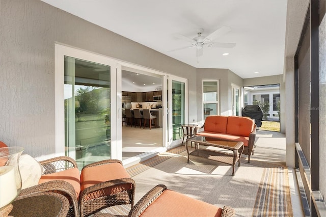 sunroom with a wealth of natural light and ceiling fan