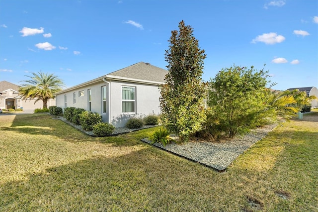 view of property exterior with a lawn