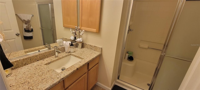 bathroom featuring a shower stall and vanity