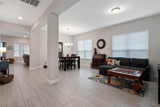 living room with a notable chandelier and a healthy amount of sunlight