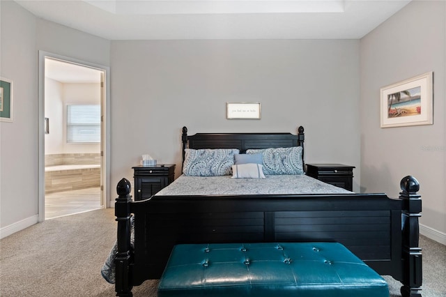 bedroom featuring carpet flooring and connected bathroom