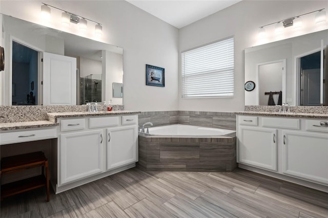 bathroom featuring vanity and separate shower and tub