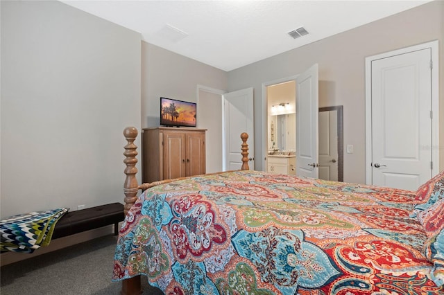 bedroom with ensuite bathroom and carpet