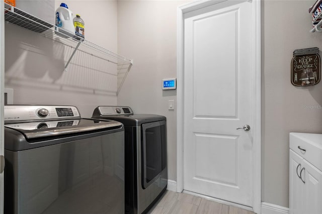 washroom with independent washer and dryer