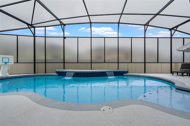 view of swimming pool with pool water feature, a lanai, and a patio area