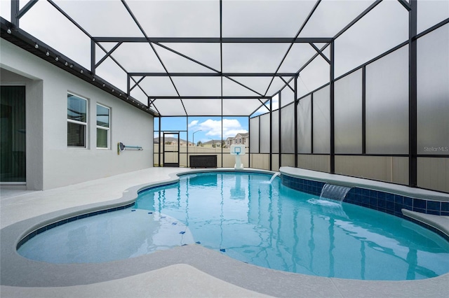 view of swimming pool with a patio, a lanai, and pool water feature