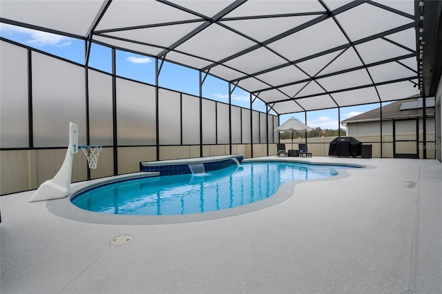 view of pool with a patio, a lanai, a grill, and pool water feature