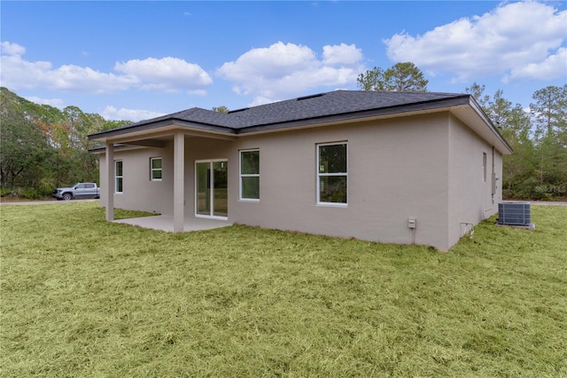 rear view of house with a yard, a patio area, and central air condition unit