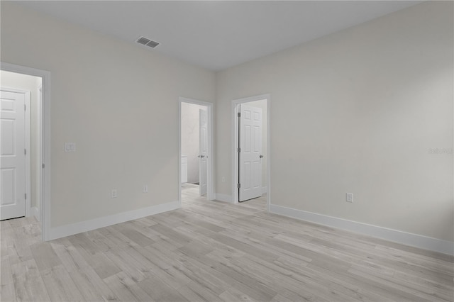 spare room with light hardwood / wood-style flooring