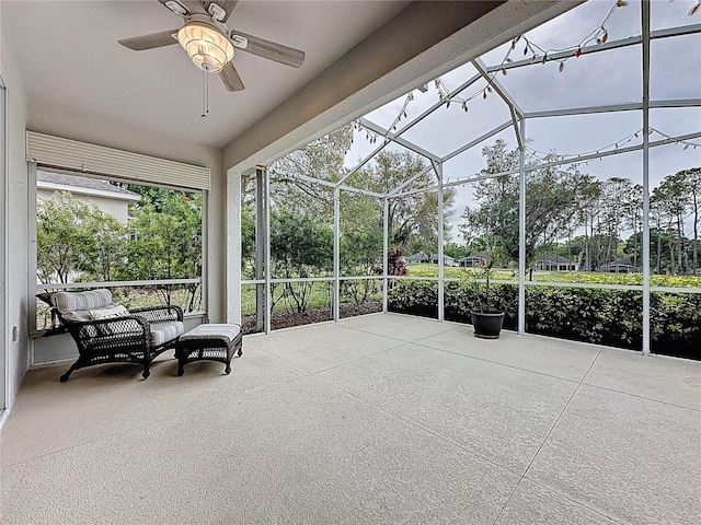 sunroom / solarium featuring ceiling fan