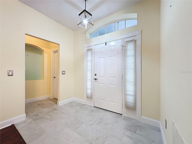 foyer entrance featuring visible vents and baseboards