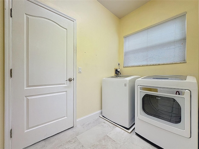 laundry area featuring laundry area, washer and clothes dryer, and baseboards