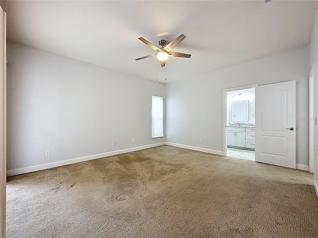 empty room with ceiling fan, baseboards, and light colored carpet