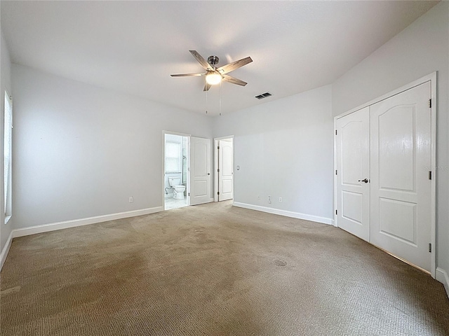 unfurnished bedroom featuring carpet floors, baseboards, visible vents, and a closet