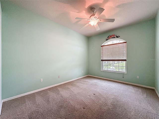 unfurnished room with a ceiling fan, a textured ceiling, baseboards, and carpet flooring