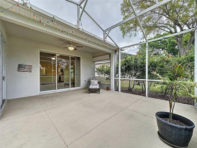 unfurnished sunroom featuring a ceiling fan