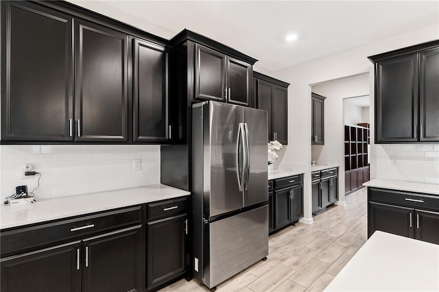 kitchen with stainless steel refrigerator and tasteful backsplash