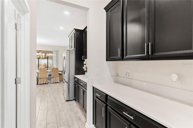 kitchen featuring an inviting chandelier and stainless steel refrigerator