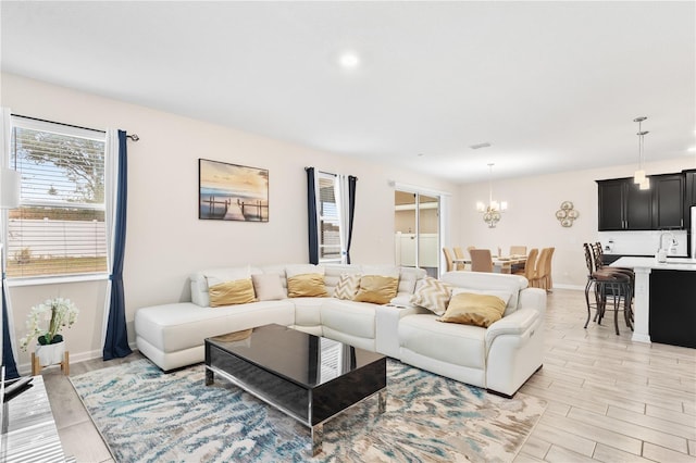 living room featuring sink and an inviting chandelier