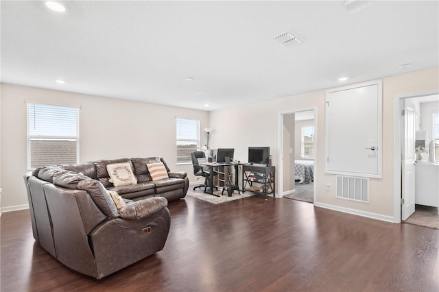 living room with plenty of natural light and dark hardwood / wood-style floors