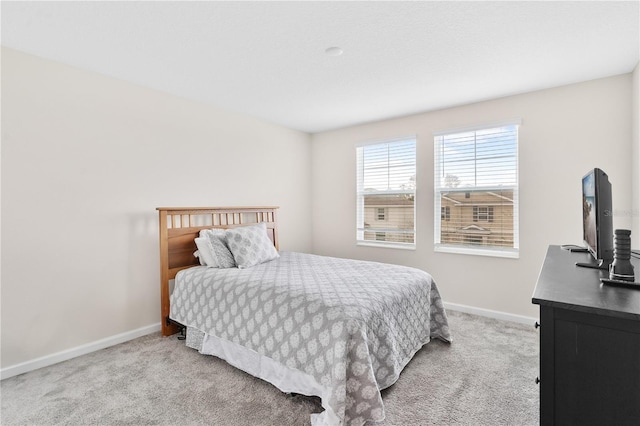 bedroom featuring light carpet