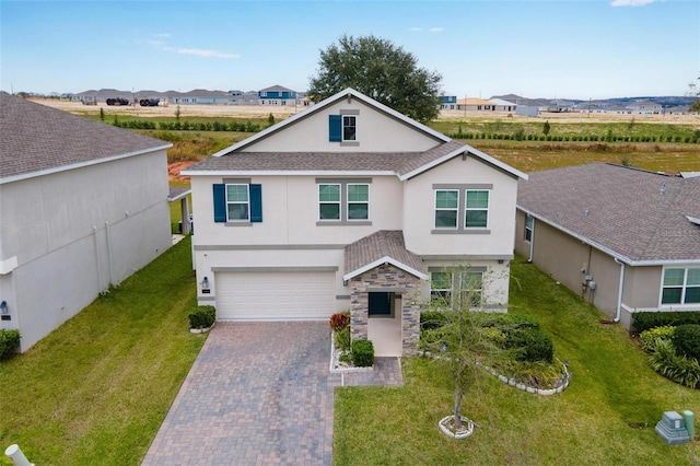 view of front of home featuring a garage and a front yard