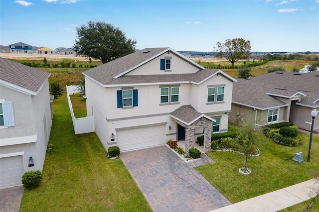 view of front of home with a garage and a front yard