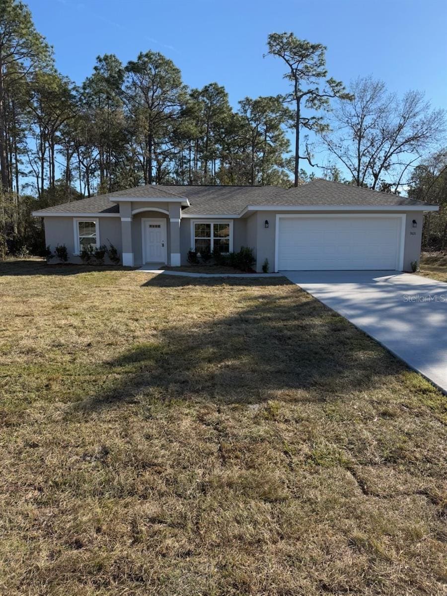 single story home with a garage and a front yard