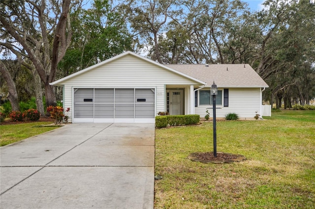 single story home featuring a garage and a front yard