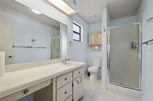 bathroom featuring vanity, tile patterned floors, toilet, and walk in shower