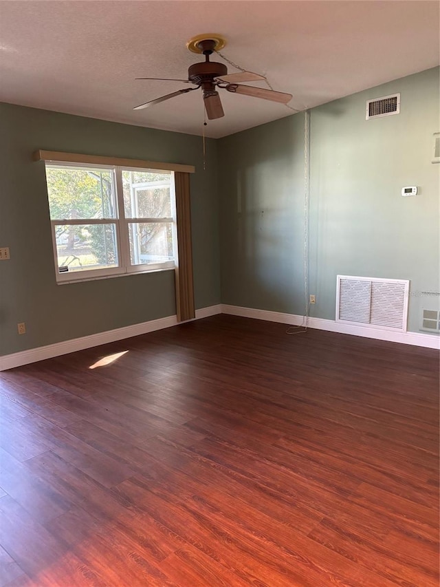 unfurnished room with dark hardwood / wood-style floors and ceiling fan