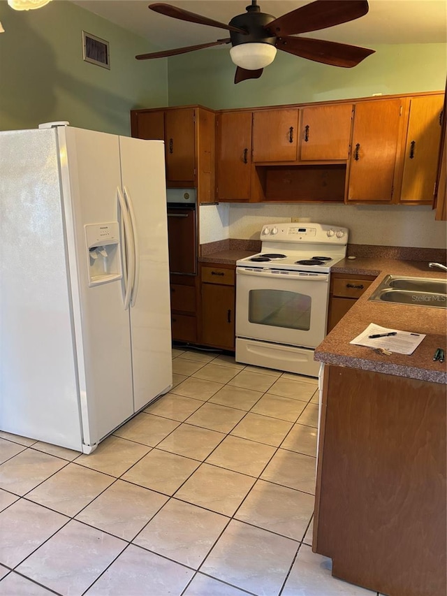 kitchen featuring sink, white appliances, light tile patterned floors, and ceiling fan