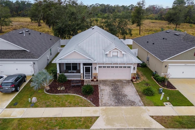 view of front facade with a garage, a front yard, and a porch