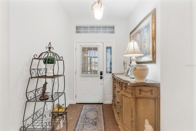 foyer entrance featuring dark tile patterned flooring