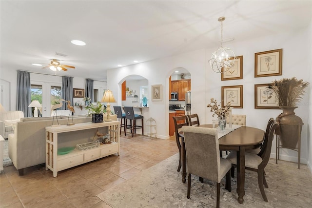 dining room featuring ceiling fan with notable chandelier