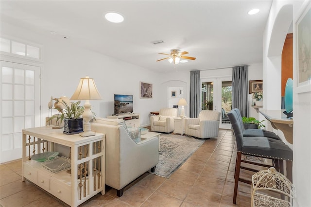 living room with ceiling fan and french doors