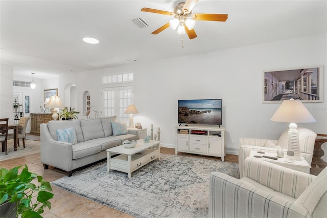 living room with light tile patterned floors and ceiling fan