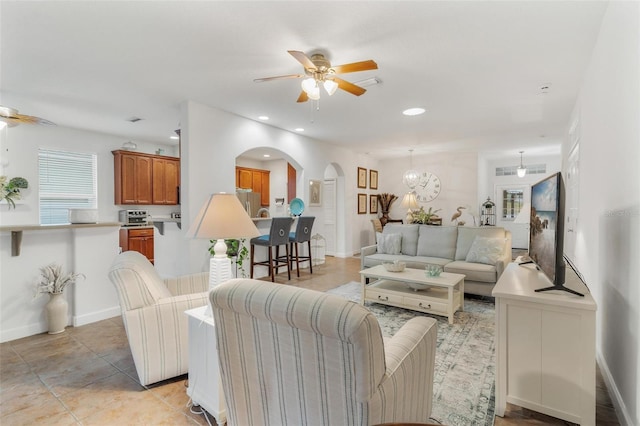 tiled living room with ceiling fan