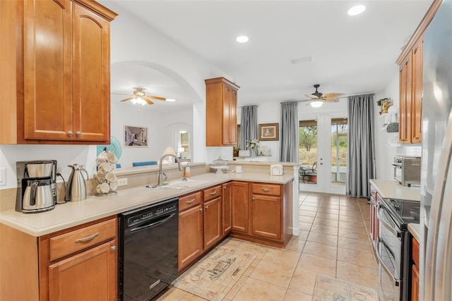 kitchen featuring dishwasher, sink, stainless steel range with electric stovetop, ceiling fan, and kitchen peninsula