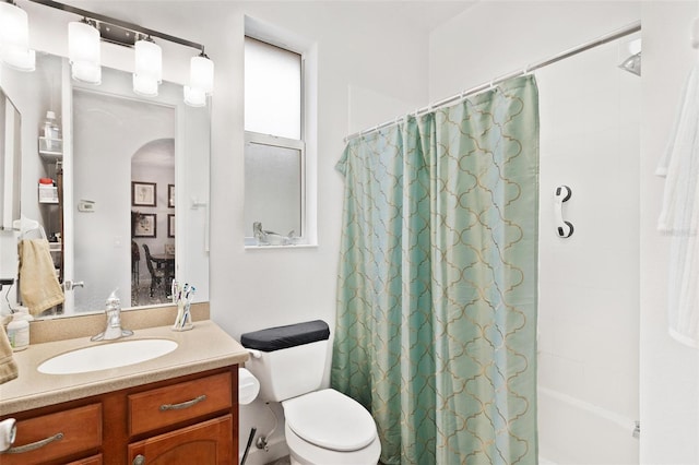 full bathroom featuring vanity, toilet, and shower / bath combo with shower curtain