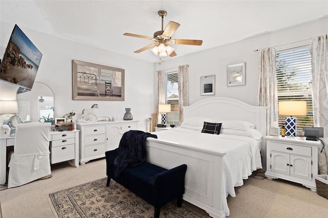 carpeted bedroom featuring ceiling fan and multiple windows