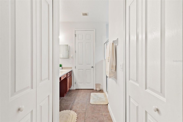 bathroom featuring vanity, tile patterned flooring, and a shower with shower door