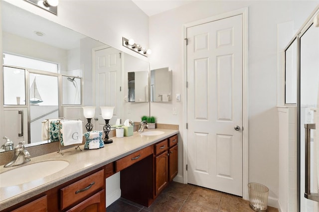 bathroom with vanity, a shower with shower door, and tile patterned floors