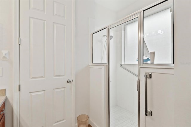 bathroom with vanity and a shower with door