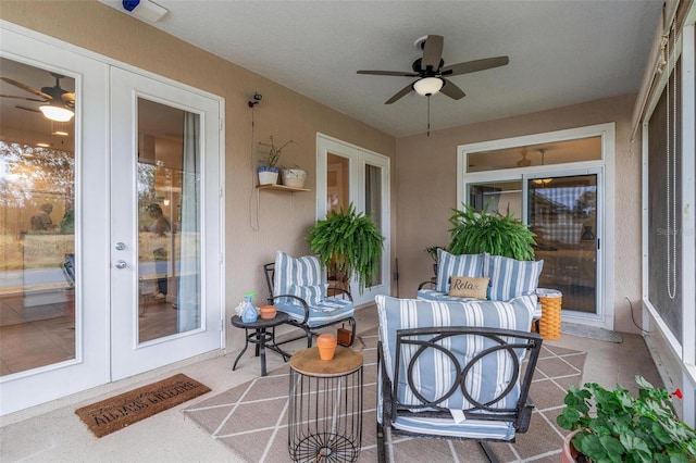 sunroom / solarium with ceiling fan and french doors