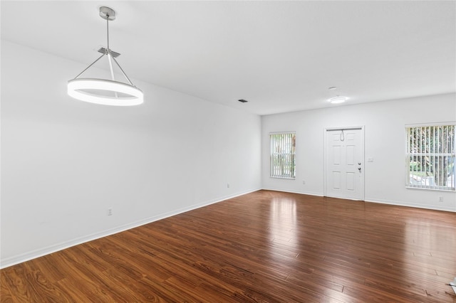 unfurnished room with dark hardwood / wood-style floors