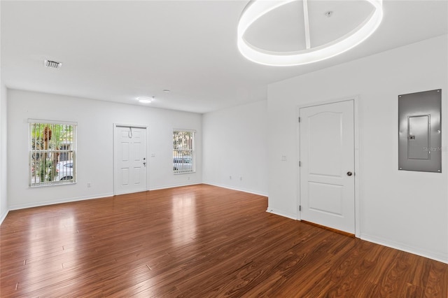 unfurnished room featuring hardwood / wood-style flooring, plenty of natural light, and electric panel