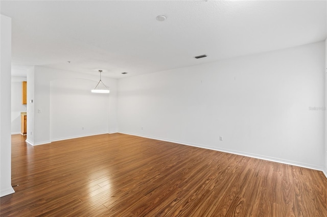 spare room with hardwood / wood-style floors