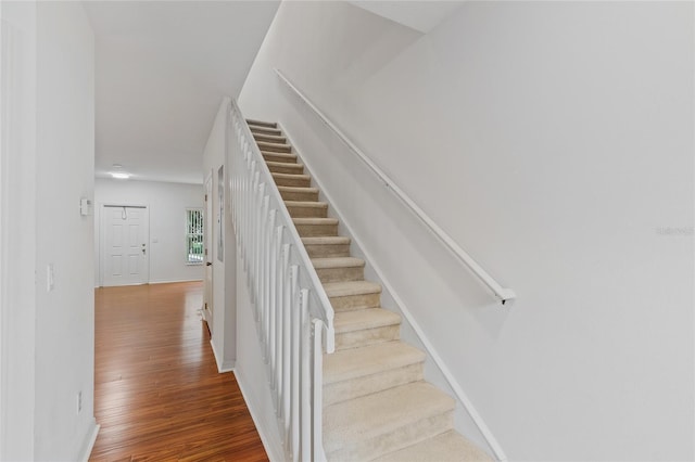 stairs featuring hardwood / wood-style floors