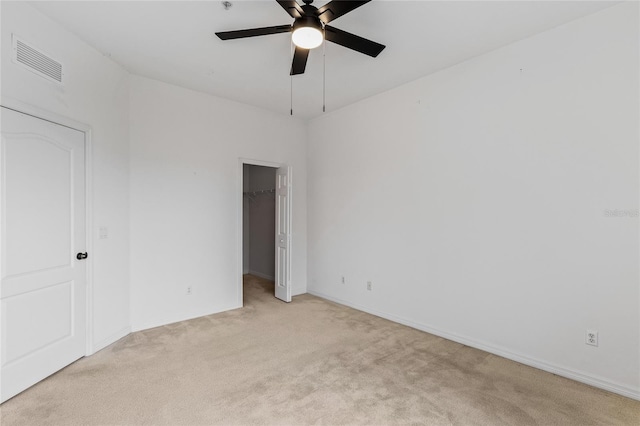 empty room with light carpet and ceiling fan